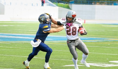 RB Brandon Gordon stiff arms a Windsor defender on Oct. 4, 2014