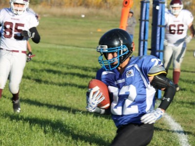 Cumberland House Islander #22 Brandon Fiddler. Leading scorer in the regular season, Brandon scored four touchdowns for the hometown Islanders. Beauval Voyaguer players in the picture are #66 Walter Hood and #85 Cory Lafleur.