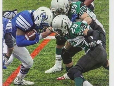 Daniel Cockburn (#39) goes for the tackle vs. Harry Ainlay High School. By Sheryl Ogonoski.