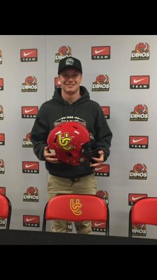 Brayden Laurie holds his new UofC helmet. Courtesy of Brayden Laurie.