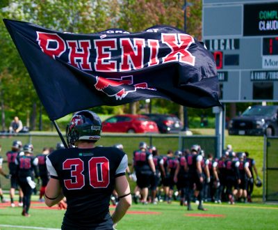 Gabriel Morel (#30) holding the Phenik flag. Courtesy of Gabriel Morel.