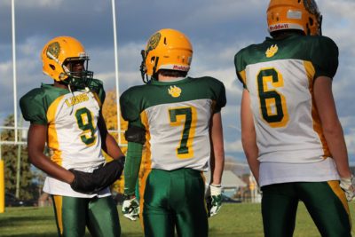 Richard Cole (#9) with his teammates on the sideline during a game