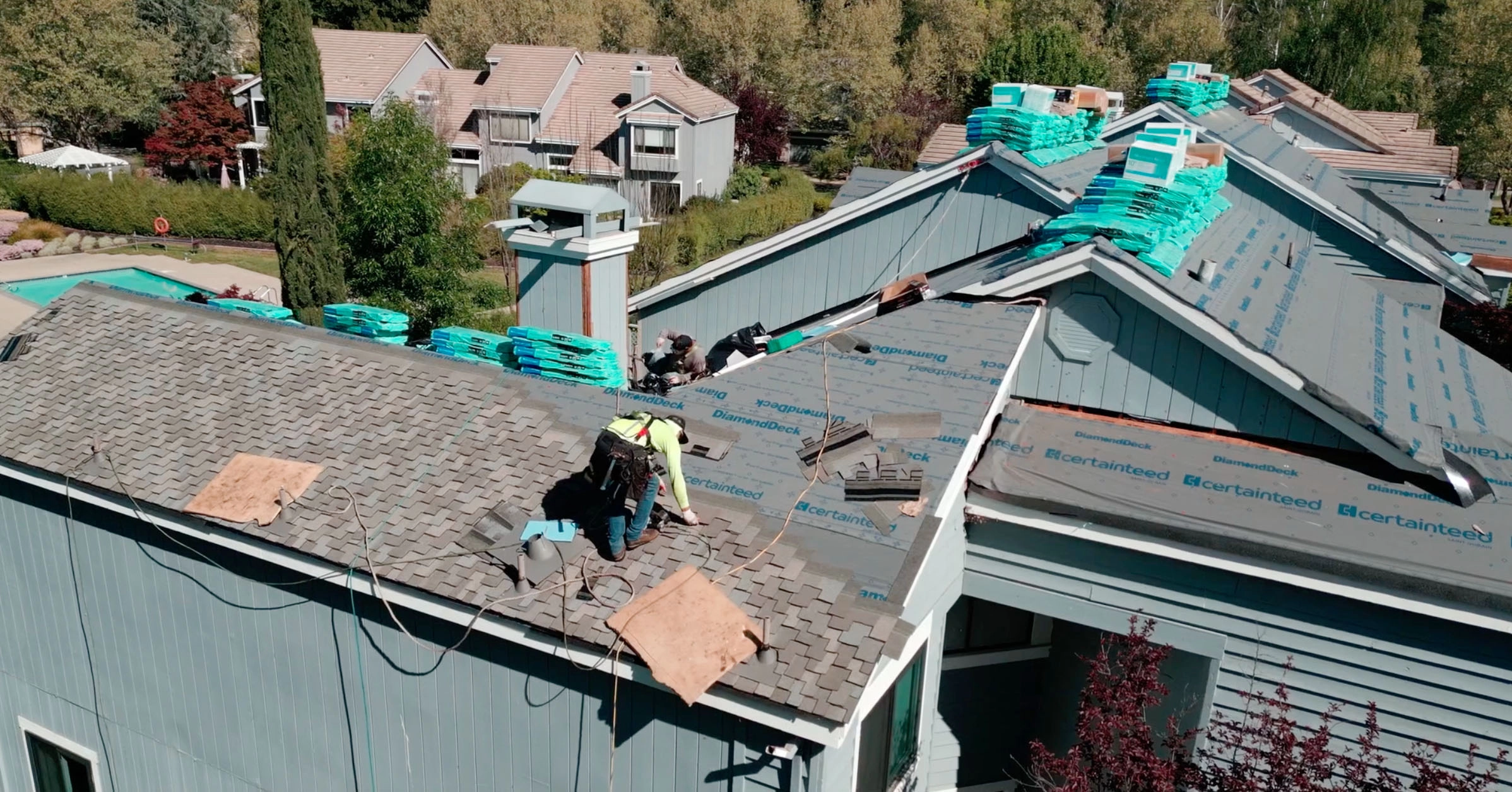 This image showcases a freshly installed asphalt shingle roof on a single-family house. The clean, uniform shingles indicate a high-quality roofing job, with neat alignment and secure placement. The photograph highlights the craftsmanship and attention to detail from Acme Roofing Services Inc., demonstrating their expertise in residential roofing solutions. The roof design features multiple slopes and dormers, adding architectural interest while providing effective water drainage. This image showcases a freshly installed asphalt shingle roof on a single-family house. The clean, uniform shingles indicate a high-quality roofing job, with neat alignment and secure placement. The photograph highlights the craftsmanship and attention to detail from Acme Roofing Services Inc., demonstrating their expertise in residential roofing solutions. The roof design features multiple slopes and dormers, adding architectural interest while providing effective water drainage.