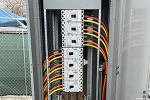 This image showcases a professionally installed electrical panel featuring neatly arranged circuit breakers and wiring. The panel's interior demonstrates meticulous attention to safety and organization, with clearly labeled breakers and clean cable management. The setup is indicative of high standards in residential or commercial electrical work, ensuring reliable power distribution and easy maintenance access.