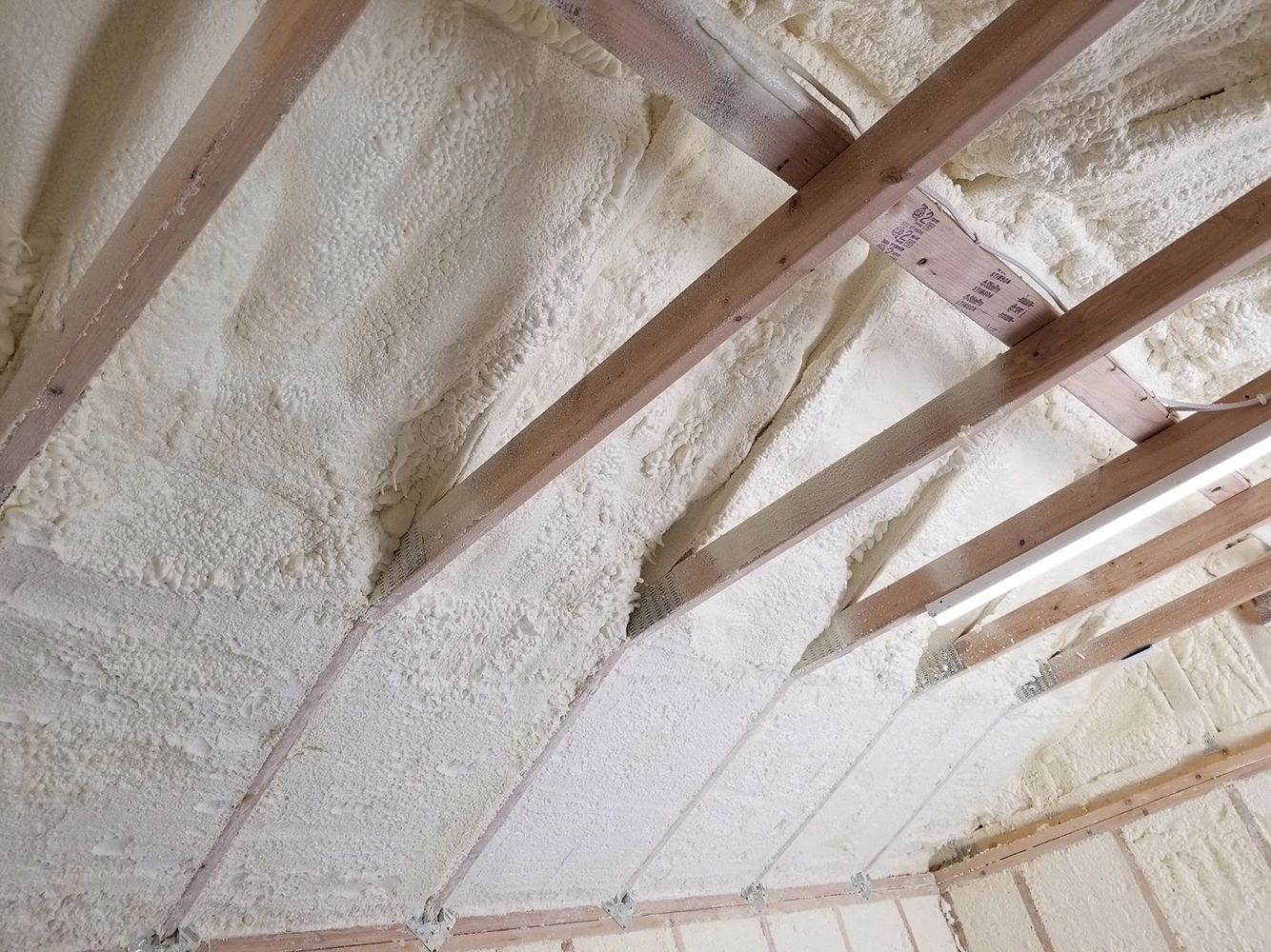 This image showcases a professional attic insulation job where thick, fluffy layers of pink fiberglass insulation have been carefully laid out between the wooden ceiling beams. The insulation material fills the entire cavity, providing effective thermal resistance to help maintain indoor temperatures and reduce energy costs. The craftsmanship is evident in the clean and even application, ensuring maximum coverage without gaps. Proper attic insulation like this plays a crucial role in improving home comfort and reducing heating and cooling expenses. This image showcases a professional attic insulation job where thick, fluffy layers of pink fiberglass insulation have been carefully laid out between the wooden ceiling beams. The insulation material fills the entire cavity, providing effective thermal resistance to help maintain indoor temperatures and reduce energy costs. The craftsmanship is evident in the clean and even application, ensuring maximum coverage without gaps. Proper attic insulation like this plays a crucial role in improving home comfort and reducing heating and cooling expenses.