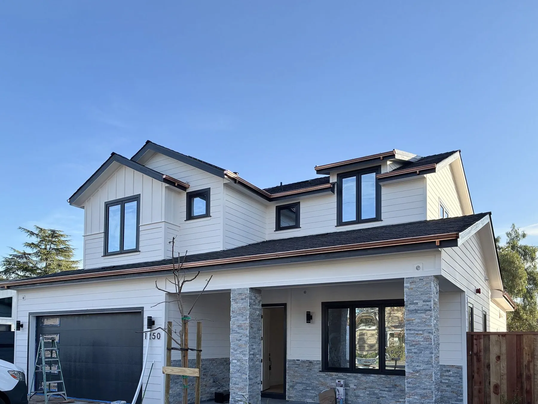 This image showcases a beautiful home exterior featuring prominent shingle dormers that add character and charm to the roofline. The dormers are crafted with wood shingles that blend seamlessly with the neutral-toned siding, creating a harmonious coastal aesthetic. Large windows in each dormer allow natural light to flood the interior spaces, while the clean lines and traditional detailing highlight the architectural sophistication of the design. The overall look is both timeless and inviting, embodying classic seaside home elements. This image showcases a beautiful home exterior featuring prominent shingle dormers that add character and charm to the roofline. The dormers are crafted with wood shingles that blend seamlessly with the neutral-toned siding, creating a harmonious coastal aesthetic. Large windows in each dormer allow natural light to flood the interior spaces, while the clean lines and traditional detailing highlight the architectural sophistication of the design. The overall look is both timeless and inviting, embodying classic seaside home elements.