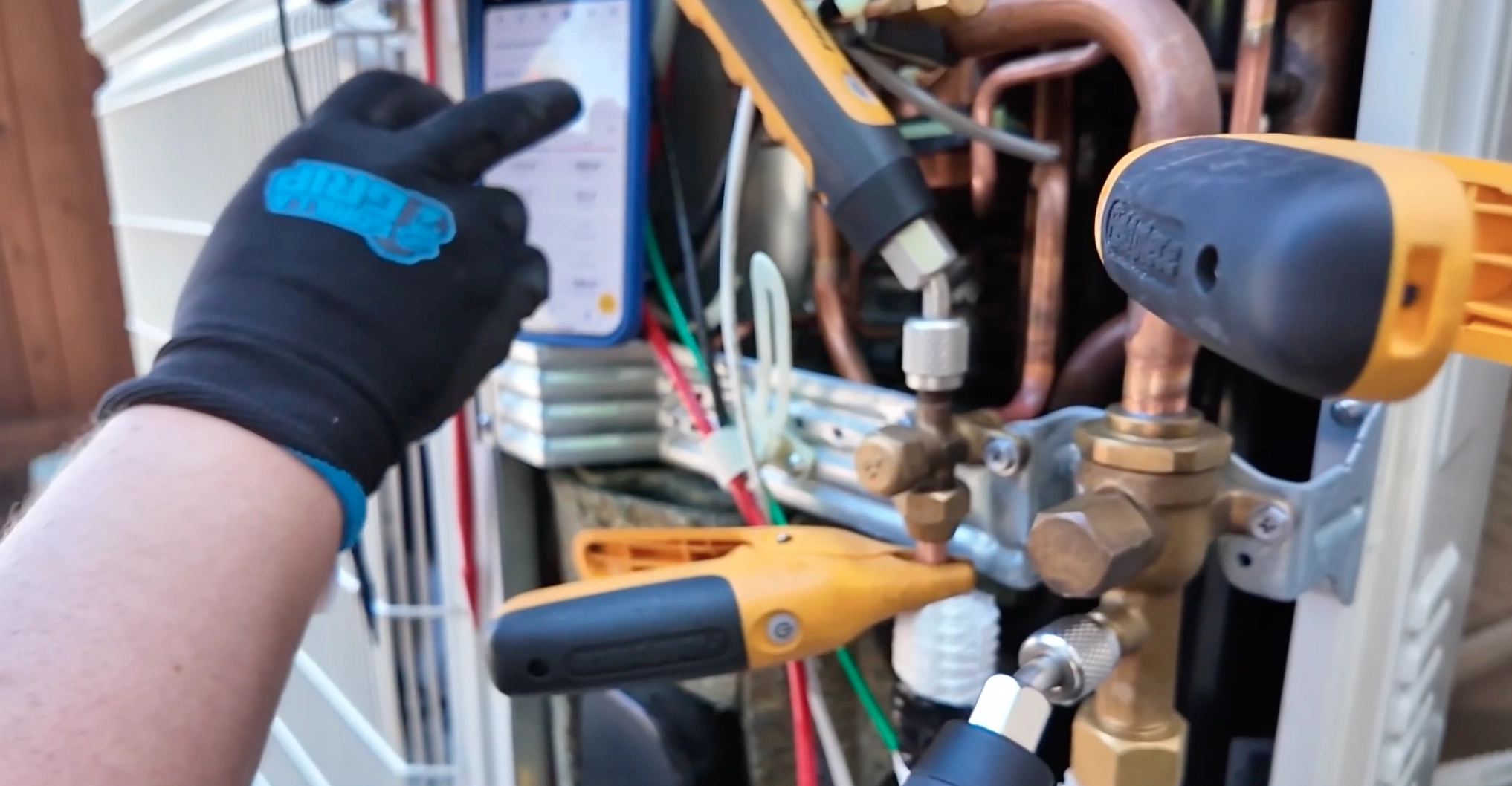 A professional technician is seen installing a new heating, ventilation, and air conditioning (HVAC) unit on the exterior wall of a building. The technician is focused on securing the metal ductwork and electrical connections of the unit, ensuring optimal placement and functionality. The HVAC system is a sleek, modern design, indicative of energy-efficient technology used to regulate indoor climate. This installation is part of ensuring comfortable living or working conditions by providing effective temperature control and air quality management. A professional technician is seen installing a new heating, ventilation, and air conditioning (HVAC) unit on the exterior wall of a building. The technician is focused on securing the metal ductwork and electrical connections of the unit, ensuring optimal placement and functionality. The HVAC system is a sleek, modern design, indicative of energy-efficient technology used to regulate indoor climate. This installation is part of ensuring comfortable living or working conditions by providing effective temperature control and air quality management.
