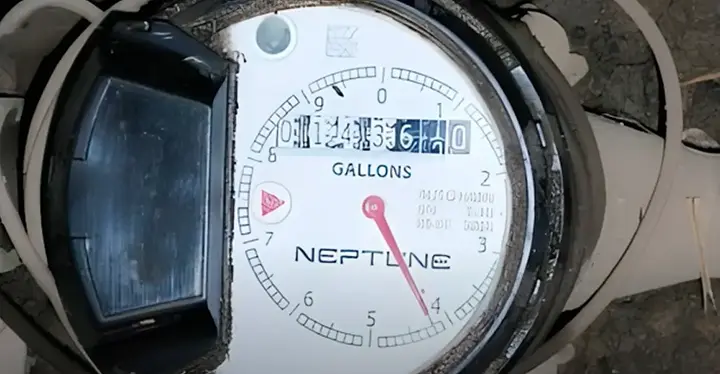 Close-up of a water meter showing numbers and gauges, indicating water usage measurement. Close-up of a water meter showing numbers and gauges, indicating water usage measurement.