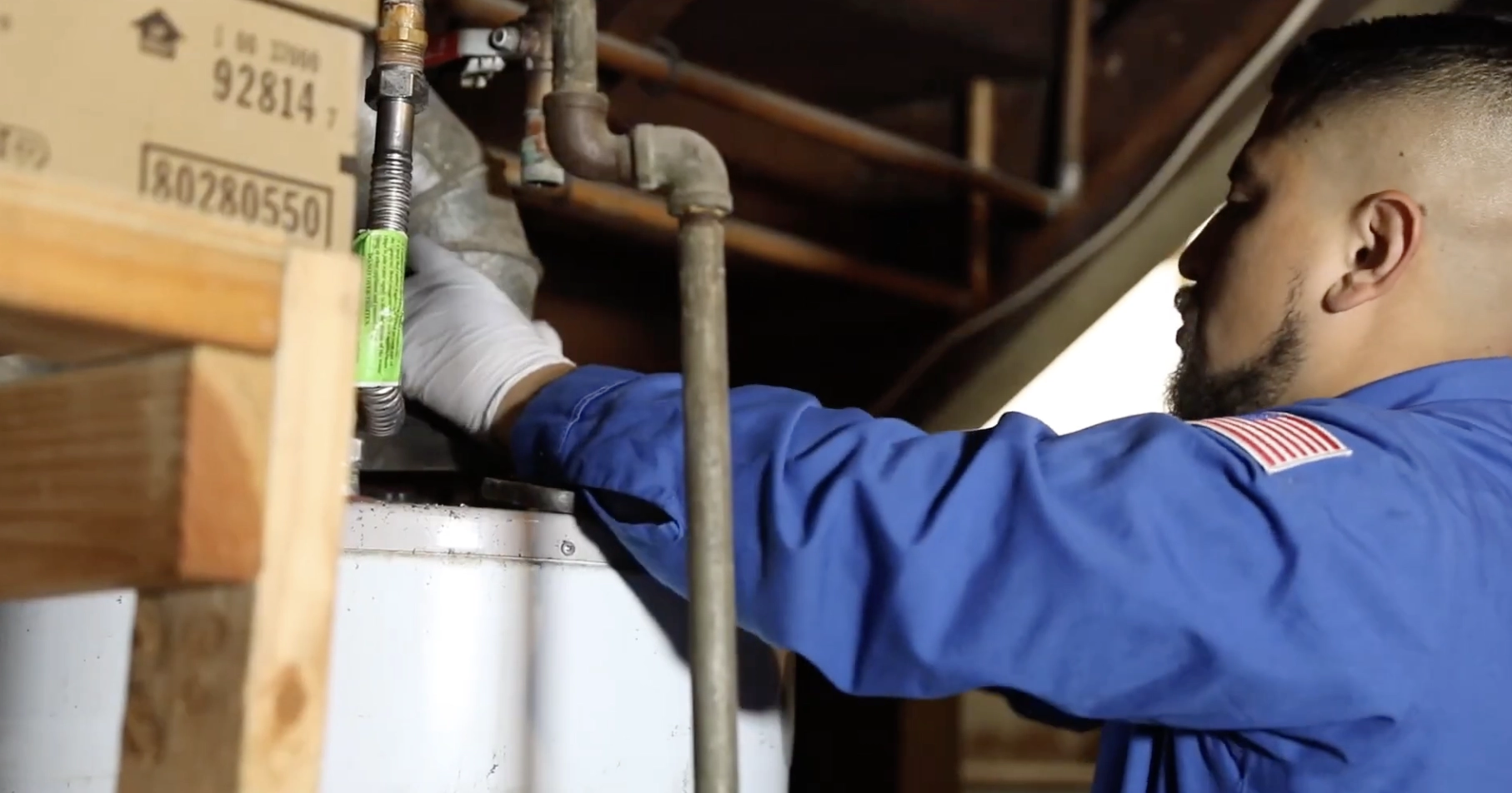 In this action shot, a professional plumber is seen working diligently beneath a kitchen sink. Equipped with essential tools, he is tightening or adjusting plumbing connections to ensure proper water flow and prevent leaks. The close-up view highlights the intricate pipes and fixtures, showcasing the plumber’s expertise and precision in handling residential plumbing maintenance or repairs. In this action shot, a professional plumber is seen working diligently beneath a kitchen sink. Equipped with essential tools, he is tightening or adjusting plumbing connections to ensure proper water flow and prevent leaks. The close-up view highlights the intricate pipes and fixtures, showcasing the plumber’s expertise and precision in handling residential plumbing maintenance or repairs.