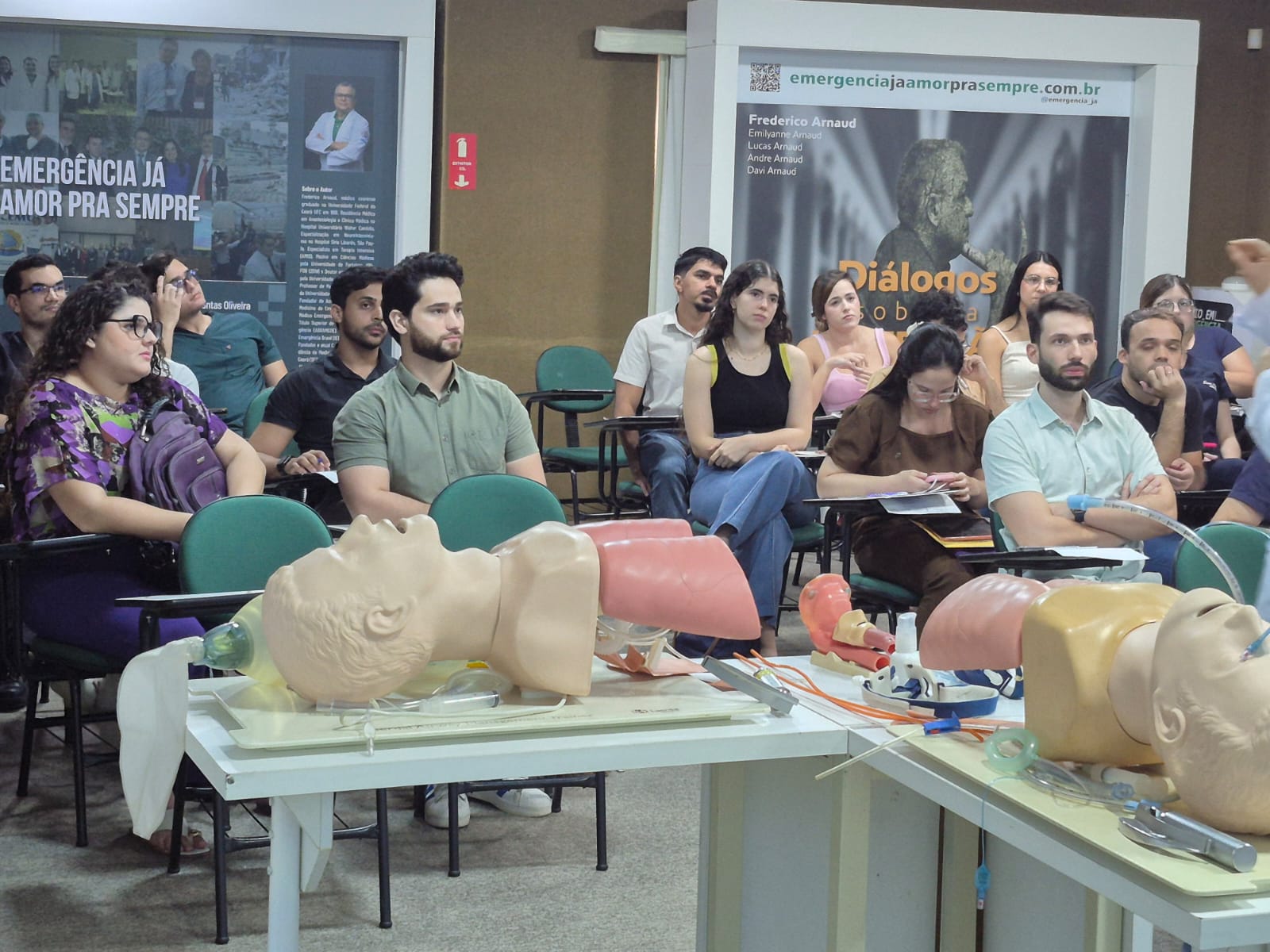 Residents attending a clinical education session with airway training equipment in the foreground
