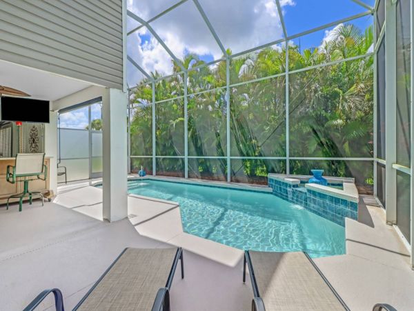 Great Outdoor Living Space with TV, Heated Pool & Outdoor Grill