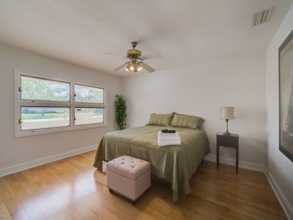 Queen bedroom on ground floor with access to hallway bathroom.
