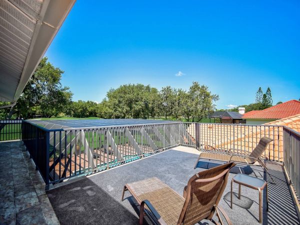 Relax on the upstairs deck overlooking the pool and golf course
