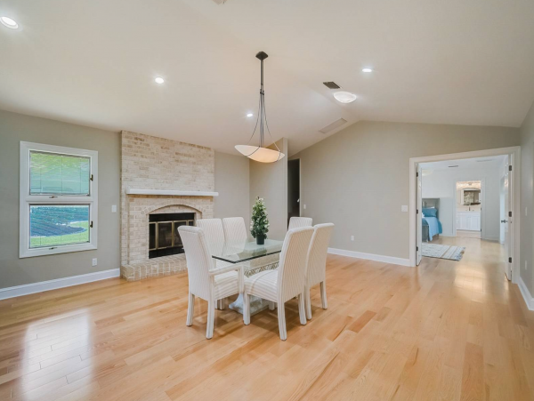 Spacious dining room with fireplace directly off the kitchen