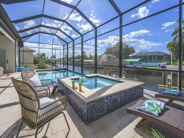 Luxurious Canal-Front Retreat with Caged Pool in Cape Coral