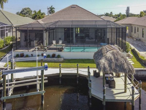 Luxurious Canal-Front Retreat with Caged Pool in Cape Coral
