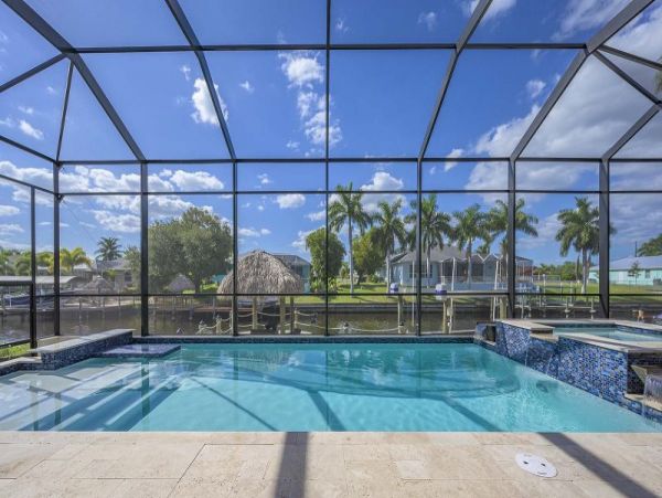 Luxurious Canal-Front Retreat with Caged Pool in Cape Coral