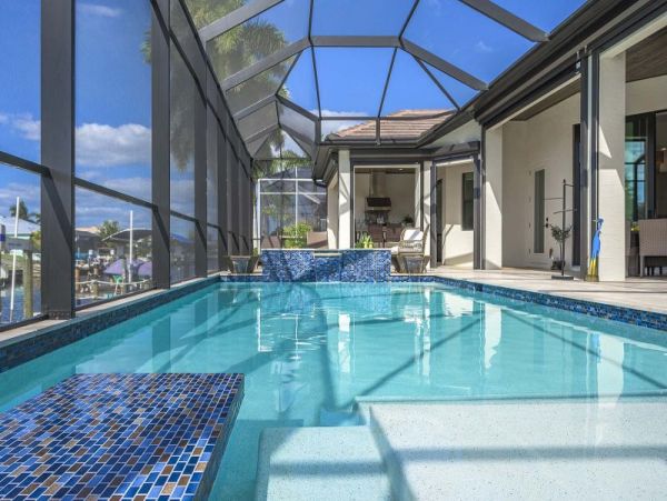 Luxurious Canal-Front Retreat with Caged Pool in Cape Coral