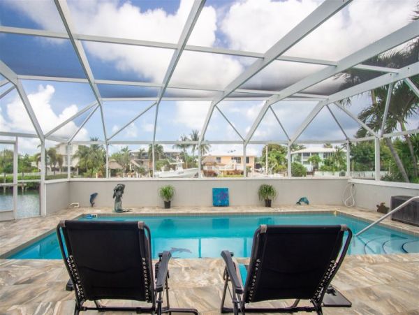 Canal Front Vacation Home with Caged Pool & Boat Dock in Marathon