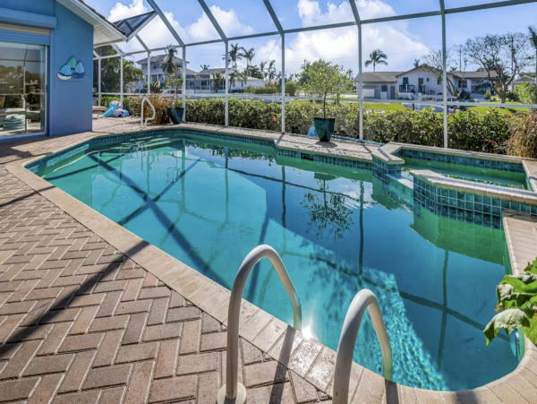 Marco Island Canalfront Four Bedroom Home with Caged Pool