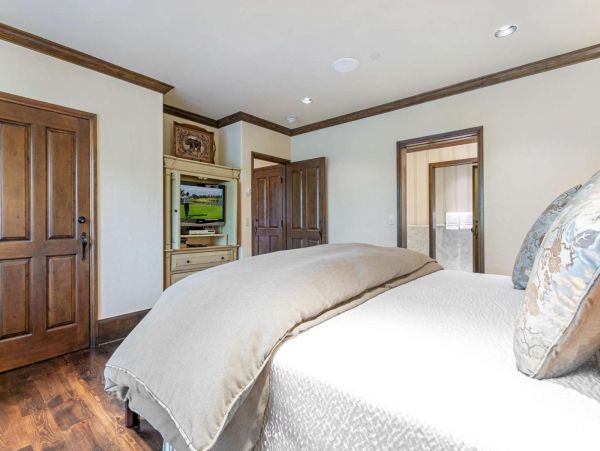Wind down watching TV in the comfort of the master bedroom.