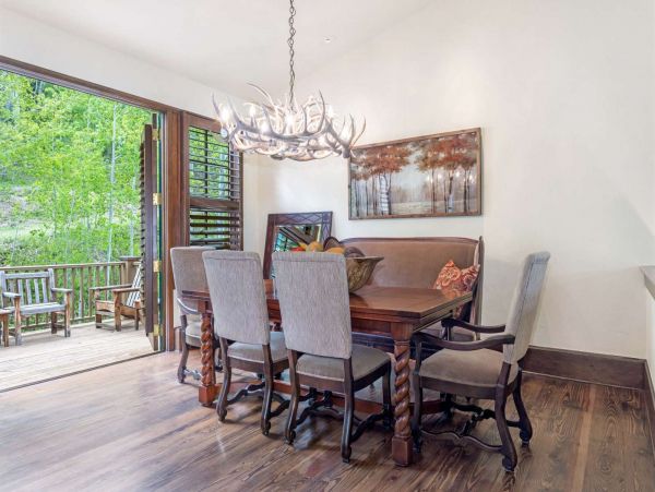Spacious dining area with table that seats 6-8 guests, this space opens to the deck with french doors.