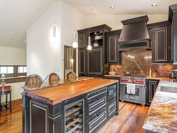 The kitchen is on the top level of the home with an open balcony that looks down on the living room area.