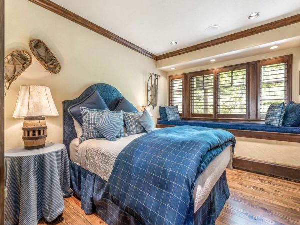 Second level queen bedroom with cozy window seat to enjoy the sunshine.