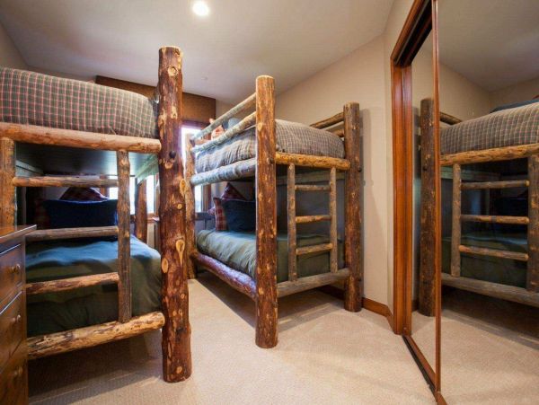 Bedroom 2 with twin over twin rustic log bunk beds. Guest bath and laundry located across the hall.