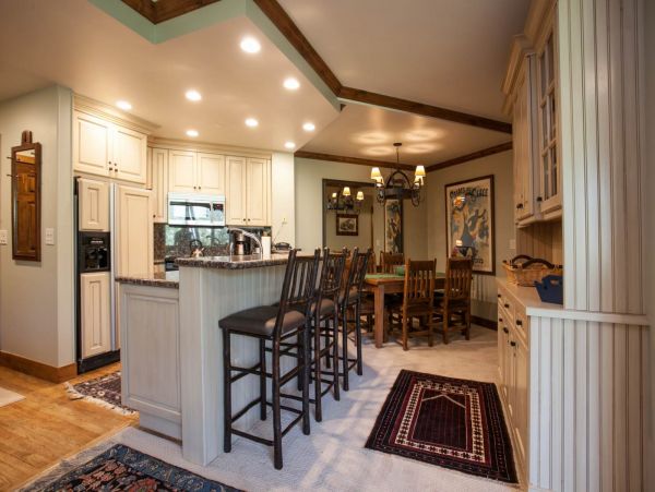 Bar with seating for 3 and dining table to accommodate 6 guests.