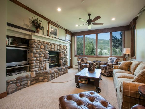 Highlands Lodge residence located on the second floor. Living room with king sofa sleeper, wood burning fireplace and flat screen TV.