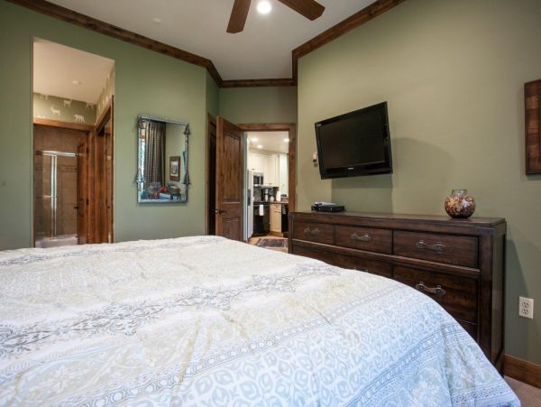 Master bedroom with en suite bath and flat screen TV, located across from kitchen.