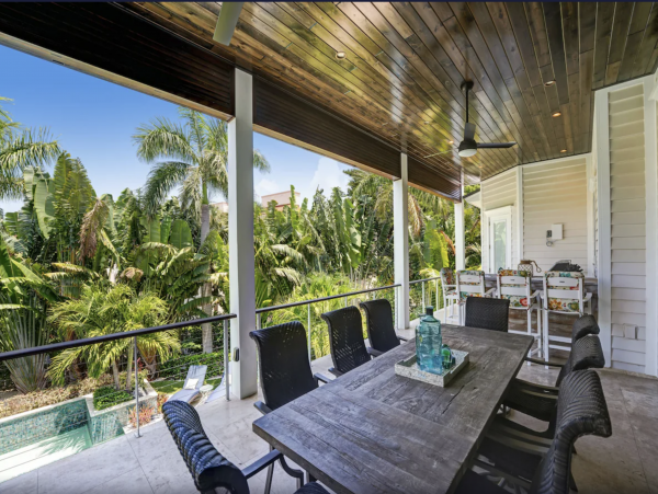 2nd level covered outdoor dining/seating area with views to pool/spa
