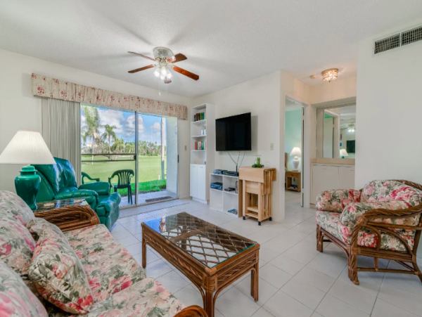 Coastal Comfort: Ground-Floor Retreat with Patio, Pool, & Beach Access