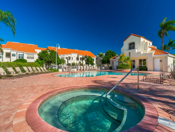 Coastal Comfort: Ground-Floor Retreat with Patio, Pool, & Beach Access