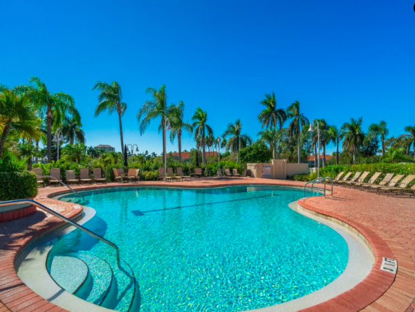 Coastal Comfort: Ground-Floor Retreat with Patio, Pool, & Beach Access
