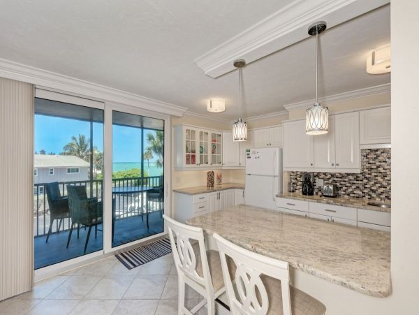 Beach front condo steps to the village