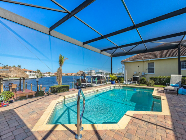 Canal Front Retreat with Gulf Access, Pool, and Tiki Dock in Cape Coral