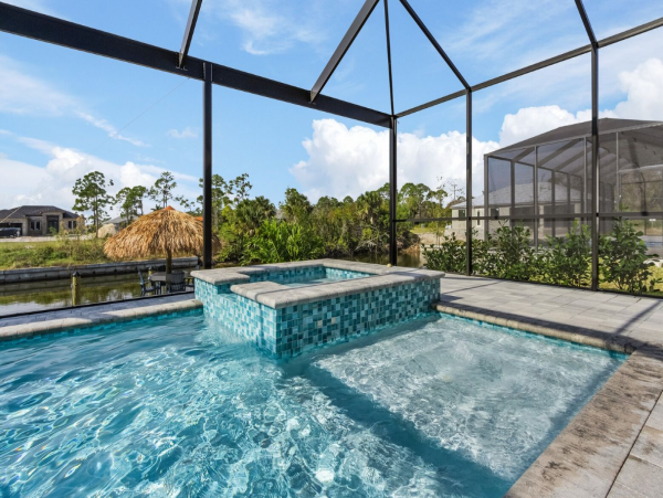 Luxury Canal Front Home with Caged Pool in Cape Coral