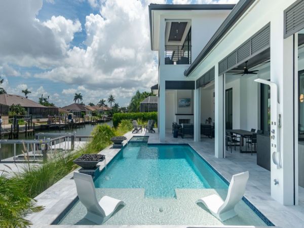 Luxurious Coastal Retreat - 4-Bedroom Waterfront Home with Pool, Theater, and Fitness Room