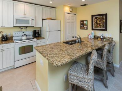Well Stocked Kitchen with Bar Seating Well Stocked Kitchen with Bar Seating