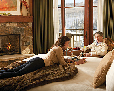 couple in Vail resort infront of fireplace couple in Vail resort infront of fireplace