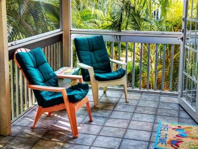 Screened balcony with comfy chairs