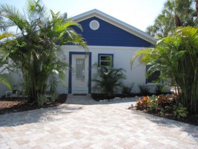 Front view of home with tropical vegetation