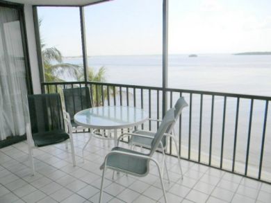 Waterfront balcony with table set