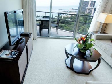Living room with flat screen TV & balcony