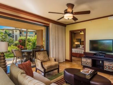 Sample living room with fat screen TV & open to porch