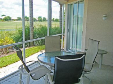 Screened lanai with outdoor table set Screened lanai with outdoor table set