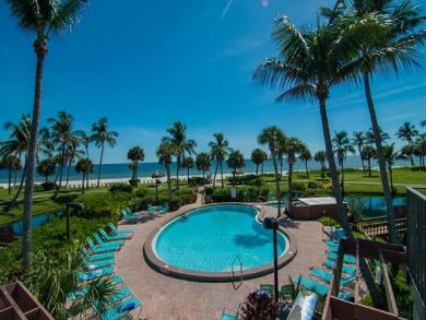 Beach front shared pool with sun loungers