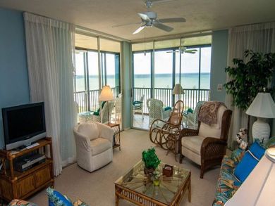 Living room with flat screen TV & balcony